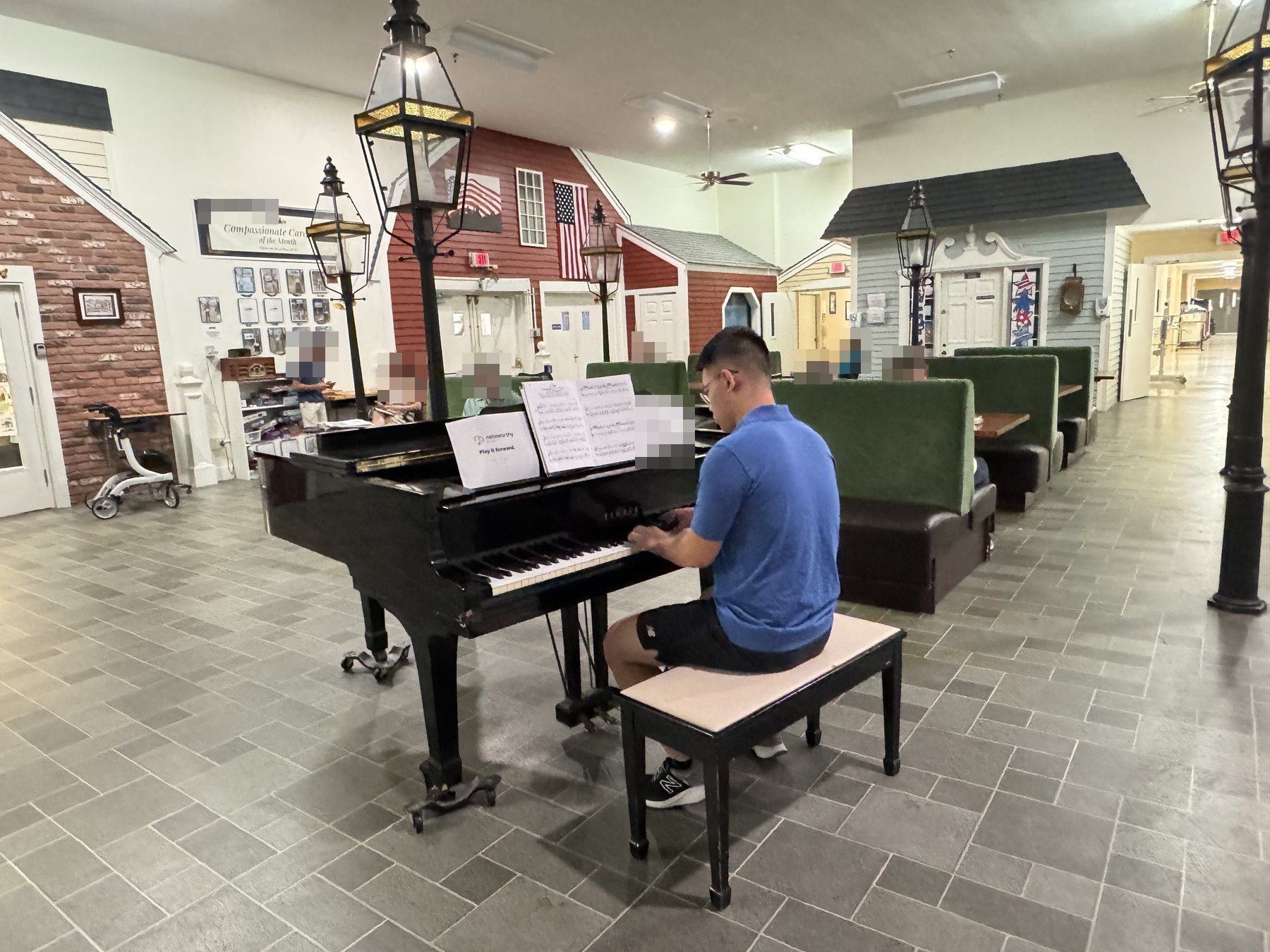 Ethan at the piano in the day room at a senior residence.